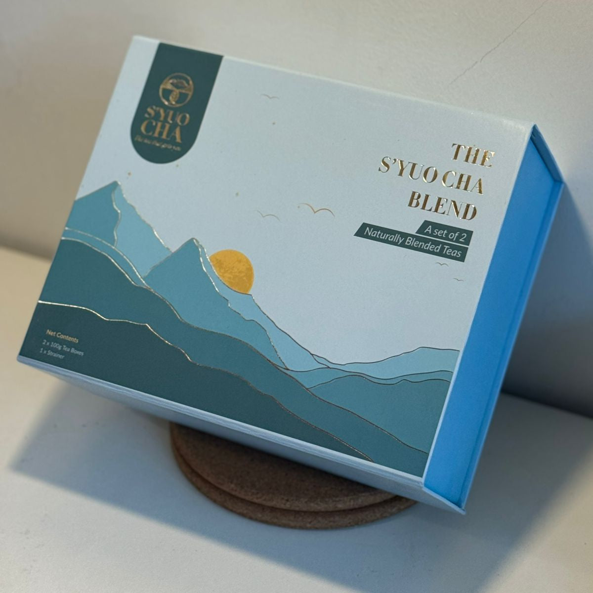 Box of 'The S'yuocha Blend' with mountain design on a white surface